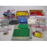 A collection of vintage Lego including building blocks, windows, trees, wheels, road signs,