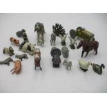 A collection of lead farm animals and tractor.