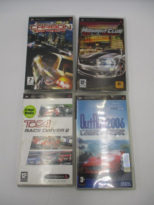 A boxed Sony PSP-2003 Piano Black handheld console with charger, along with four PSP games ( - Image 10 of 10