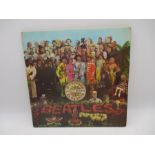 The Beatles - St Peppers Lonely Hearts Club Band 12" vinyl album with cut out card enclosed (