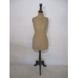 A vintage Levine & Sons dress form on ebonised tripod stand