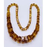 An amber necklace with square cut amber beads, 115g