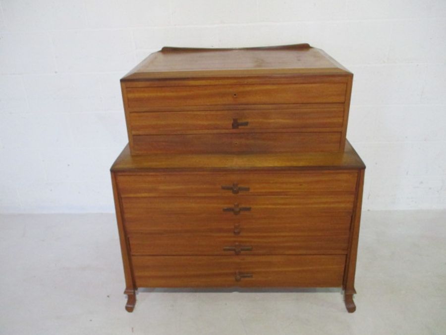 A mid-century two-tier plan chest with eight drawers