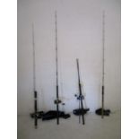 Four fishing rods, three with reels, makes including Fladen, Okuma and Savage AR etc.