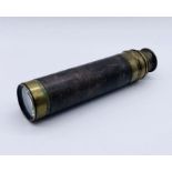 A three draw brass telescope with lens cover and brass binding