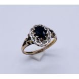 A hallmarked 9ct gold sapphire and diamond cluster ring