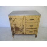 A industrial style kitchen unit with zinc top, three drawers and cupboard