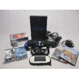 An unboxed Sony Playstation 2 with memory card, power cable, eye toy, two controllers and a small