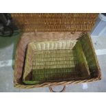 A wicker picnic hamper along with a similar tray.