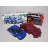 A boxed Tamiya remote control Rover Mini Cooper racing car, along with a boxed Asahi Digital