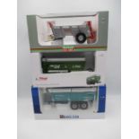 A collection of three boxed die-cast model farming trailers including a Universal Hobbies