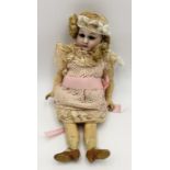An antique small Simon & Halbig bisque head doll with blonde hair and painted shoes - some repair