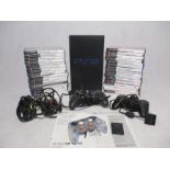 An unboxed Sony Playstation 2 console with three controllers, power cable, memory card and selection
