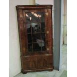 A Georgian walnut corner unit with cupboard under - approx. height 225cm, width 122cm