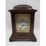 A turn of the century bracket clock with chased silvered dial, carved and fretted decoration to