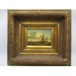 An oil painting of boats on the beach in heavy ornate gilt frame