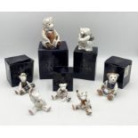 A collection of Royal Crown Derby teddy bears and paperweights including a large bear with silver