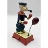 A reproduction cast iron novelty Popeye boxing toy