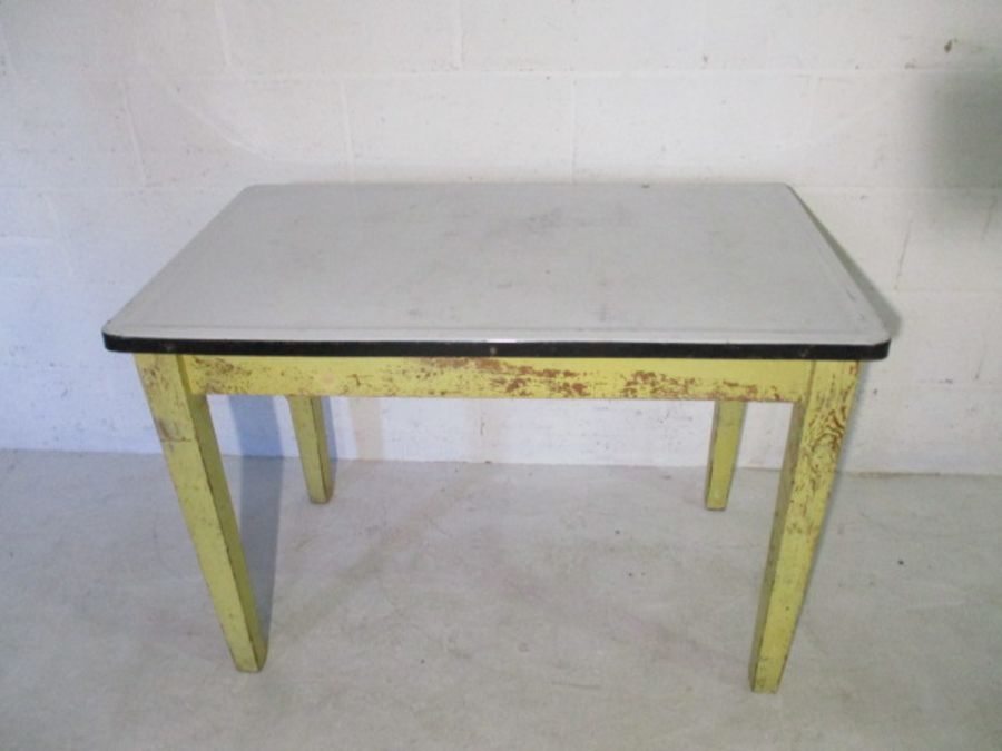 A vintage kitchen table with enamelled top