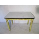 A vintage kitchen table with enamelled top