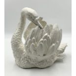 A Continental porcelain centrepiece modelled as a swan preening itself, its head turned to the side,