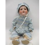 An Armand Marseille bisque headed doll stamped to reverse 990 with open mouth and teeth showing