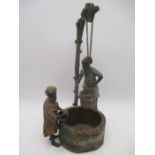 A cold painted spelter figure group in the Bergman style of two Arabs at a well, height approx.