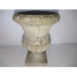 A single reconstituted stone garden urn.