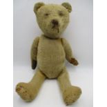 A vintage straw filled teddy bear