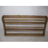 An antique pine wall hanging plate rack