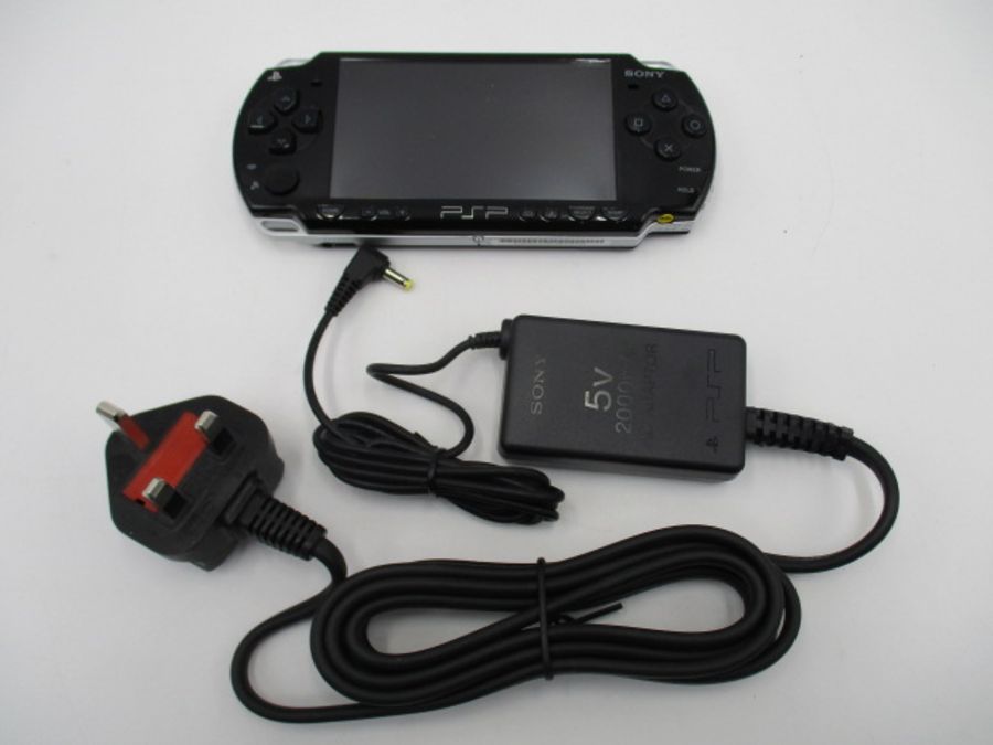 A boxed Sony PSP-2003 Piano Black handheld console with charger, along with four PSP games ( - Image 9 of 10
