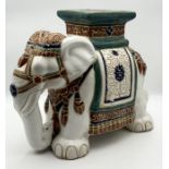 A pottery plant stand in the form of an elephant with green and white decoration