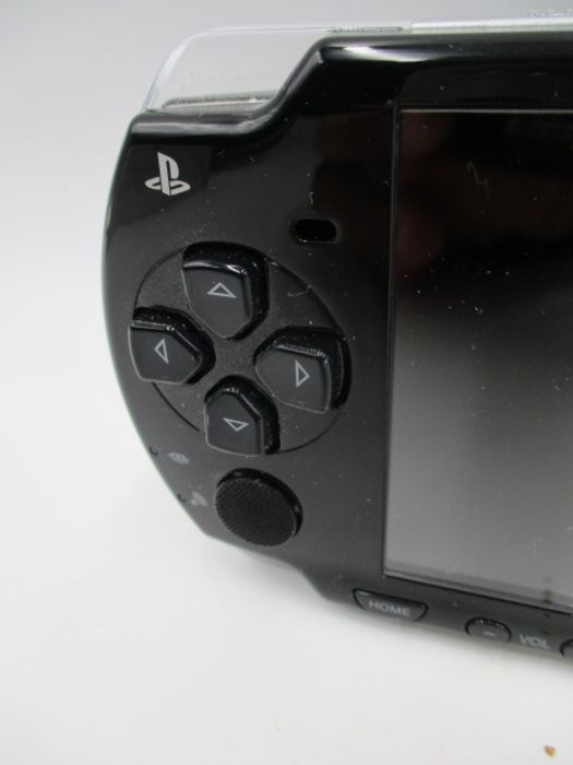 A boxed Sony PSP-2003 Piano Black handheld console with charger, along with four PSP games ( - Image 5 of 10