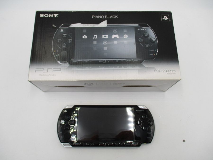 A boxed Sony PSP-2003 Piano Black handheld console with charger, along with four PSP games ( - Image 3 of 10