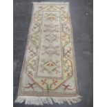 A beige ground rug with geometric designs