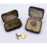 A cased pair of 9ct gold studs, a single 9ct gold cufflink and a hallmarked silver brooch, total