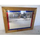 A pine framed mirror with coloured glass panels