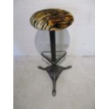 A Victorian style cast iron stool with integral foot rest.