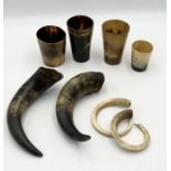 A small collection of horn cups and animal tusks including warthog etc.