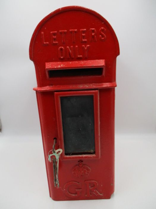 A cast iron Royal Mail letter box/postbox with a dome top and side mount fitments, stamp marked with