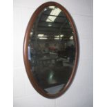 An Edwardian oval mirror.