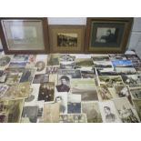A collection of vintage photographs, postcards and in memoriam cards.
