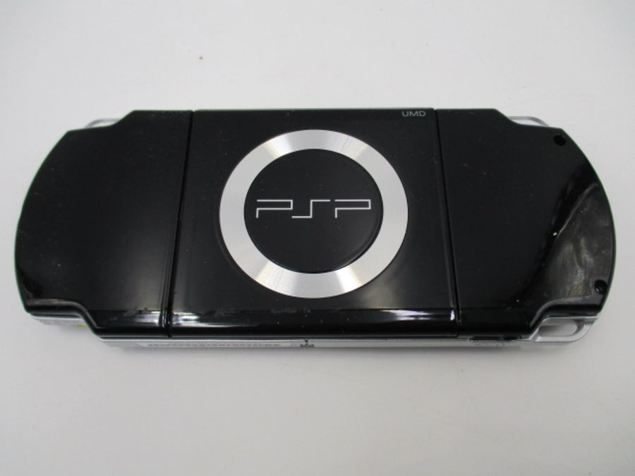 A boxed Sony PSP-2003 Piano Black handheld console with charger, along with four PSP games ( - Image 8 of 10