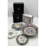 A small collection of china including three boxed cups and saucers and an Oriental enamel dish