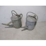 Two vintage galvanised watering cans