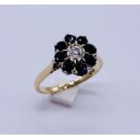 A 9ct gold diamond and sapphire cluster ring