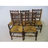 A matched set of five country chairs with rush seats