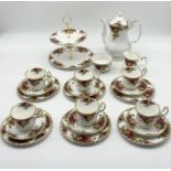 A Royal Albert Country Roses part tea set including six trios, teapot, sugar bowl, cake stand,
