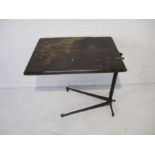 An adjustable bed table with cast iron support