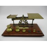 A turn of the Century set of postal scales on mahogany base, mismatched weights